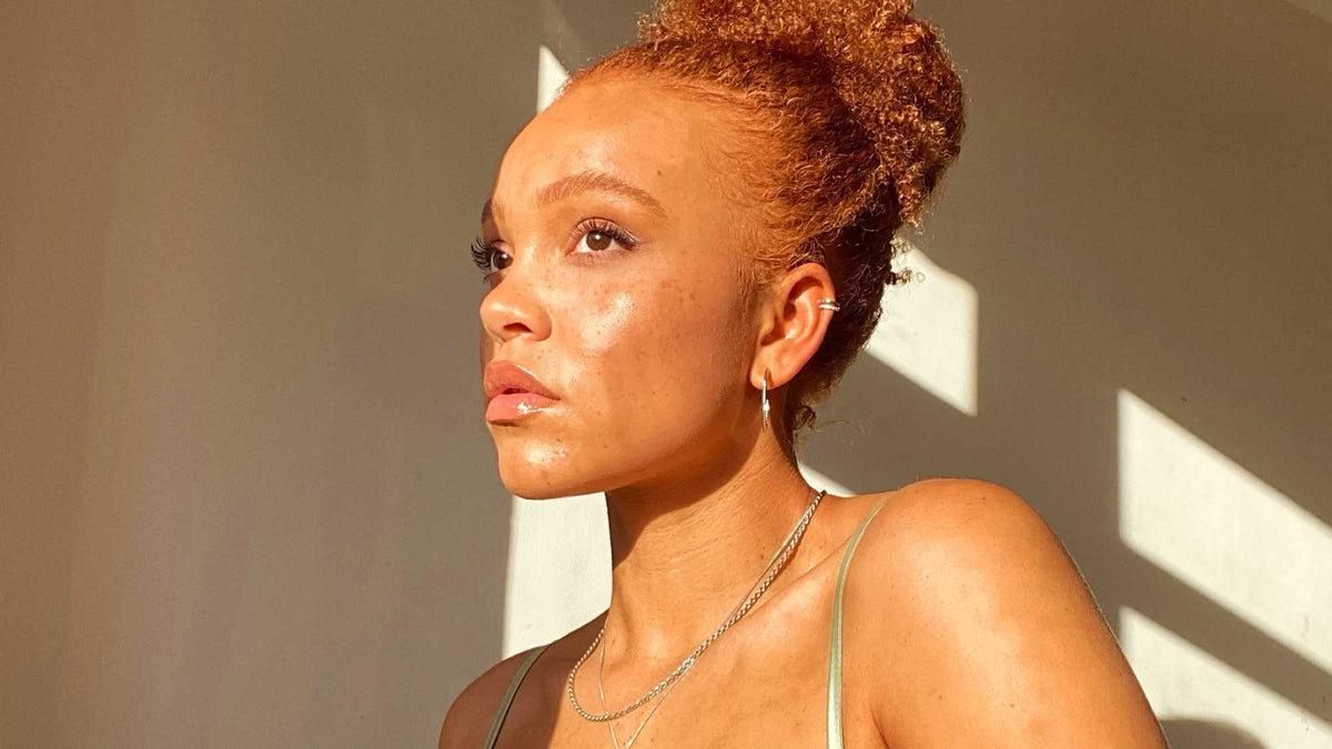 Woman wearing sparkling jewellery from the Aurora light-inspired collection from Astrid & Miyu.