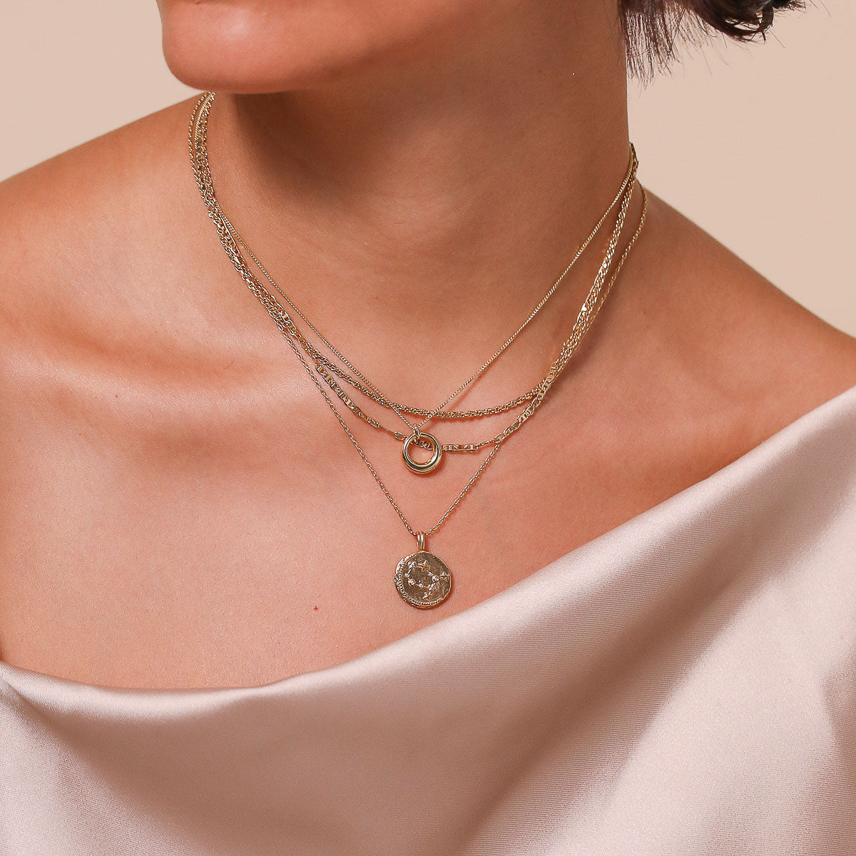 Gemini Zodiac Pendant Necklace in Gold worn layered with necklaces
