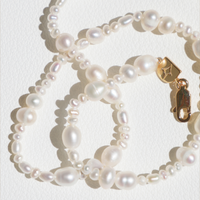 Q2_26_Notification_Bell_SS_PearlNecklace-Astrid & Miyu