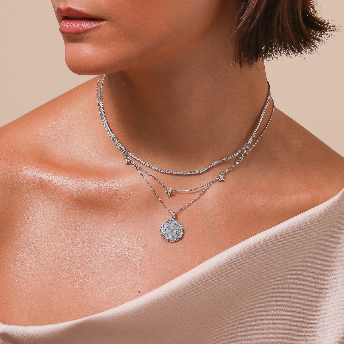 Sagittarius Zodiac Pendant Necklace in Silver worn layered with necklaces