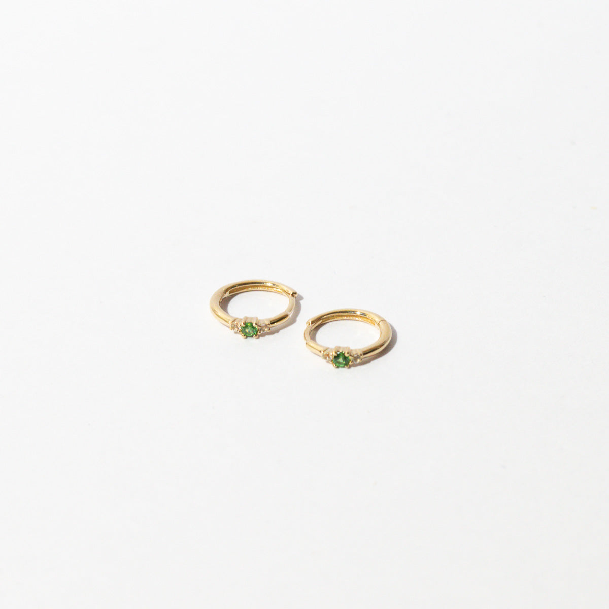 Tsavorite Hoops in Solid Gold flat lay
