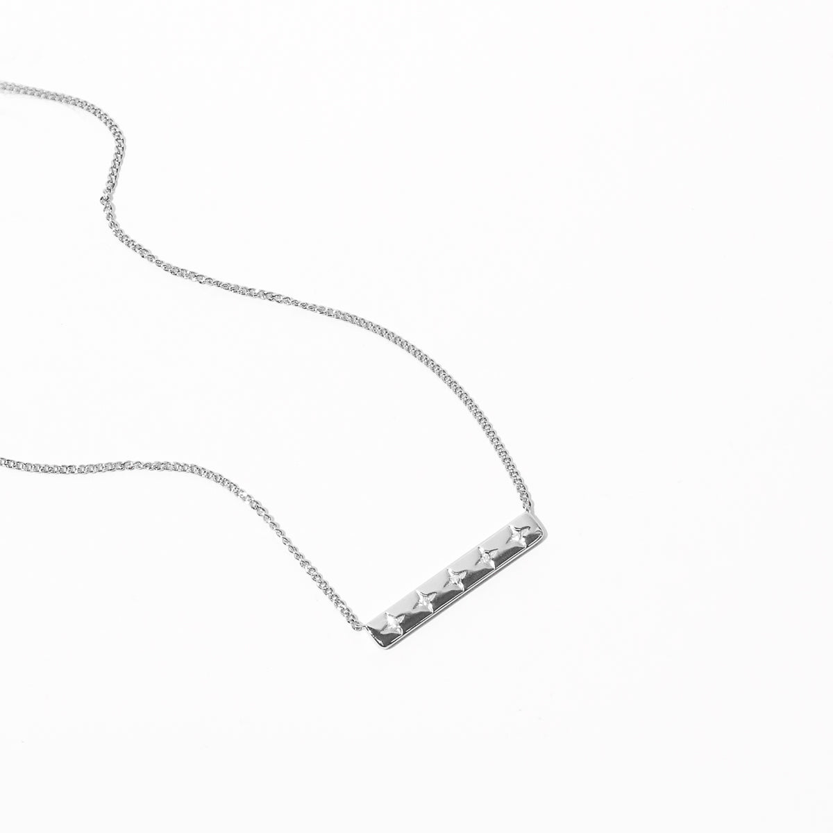 Cosmic Star Bar Necklace in Silver flat lay shot
