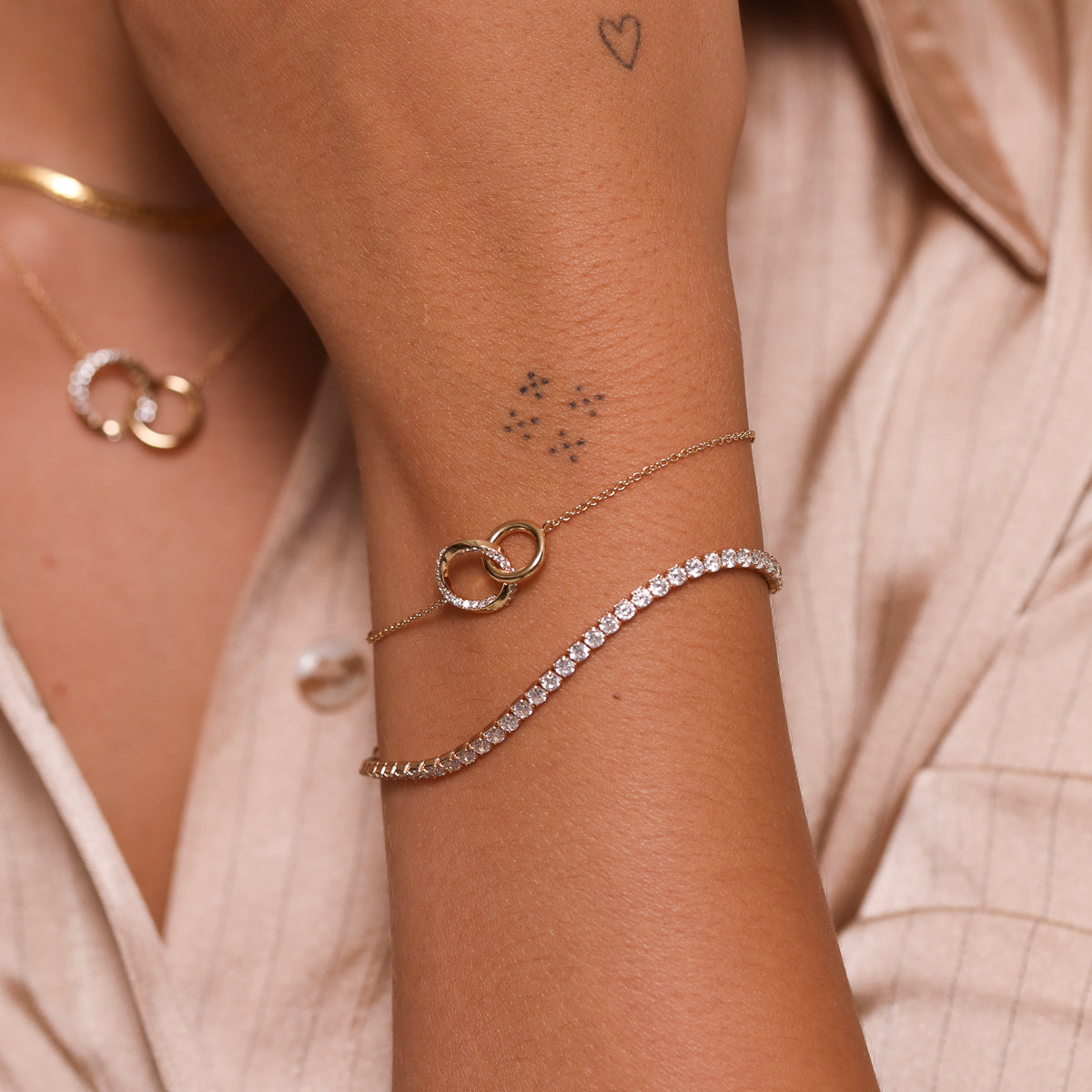 Orbit Crystal Bracelet in Gold worn with Tennis Bracelet in Gold