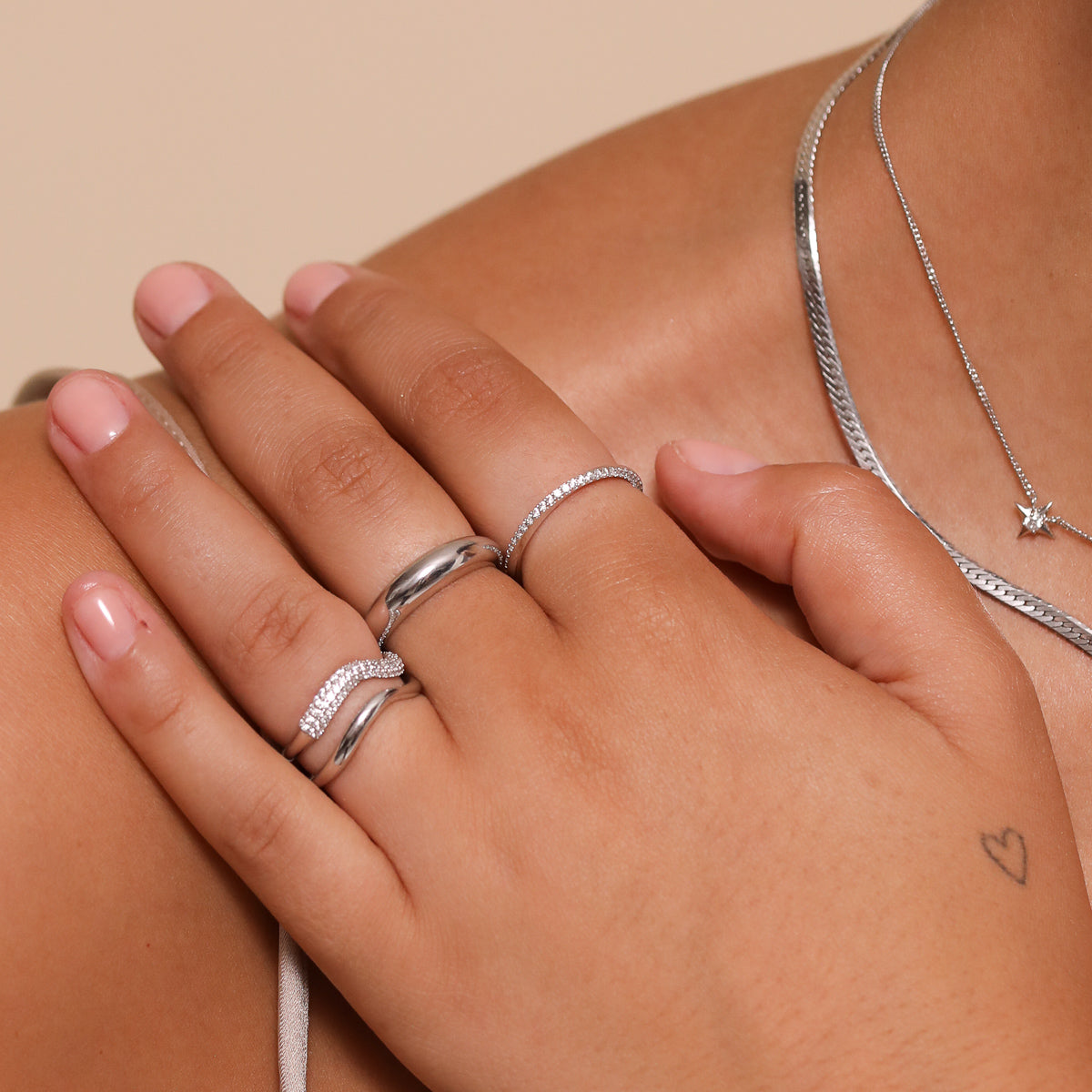 Orbit Crystal Band Ring in Silver worn stacked with other rings