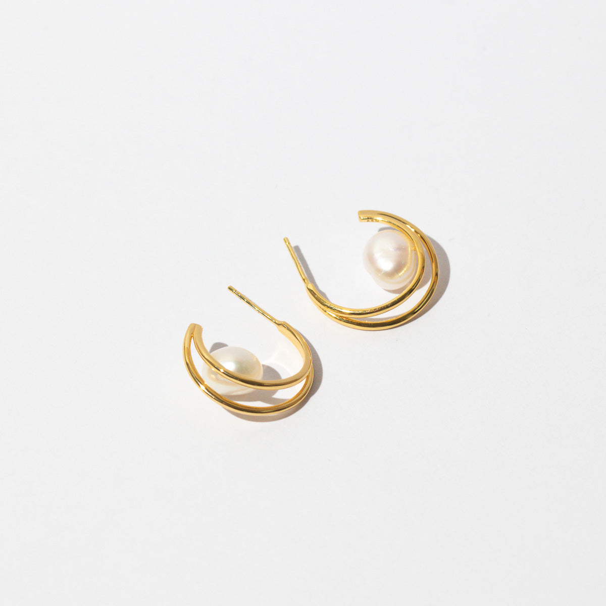 Opulent Pearl Hoops in Gold flat lay