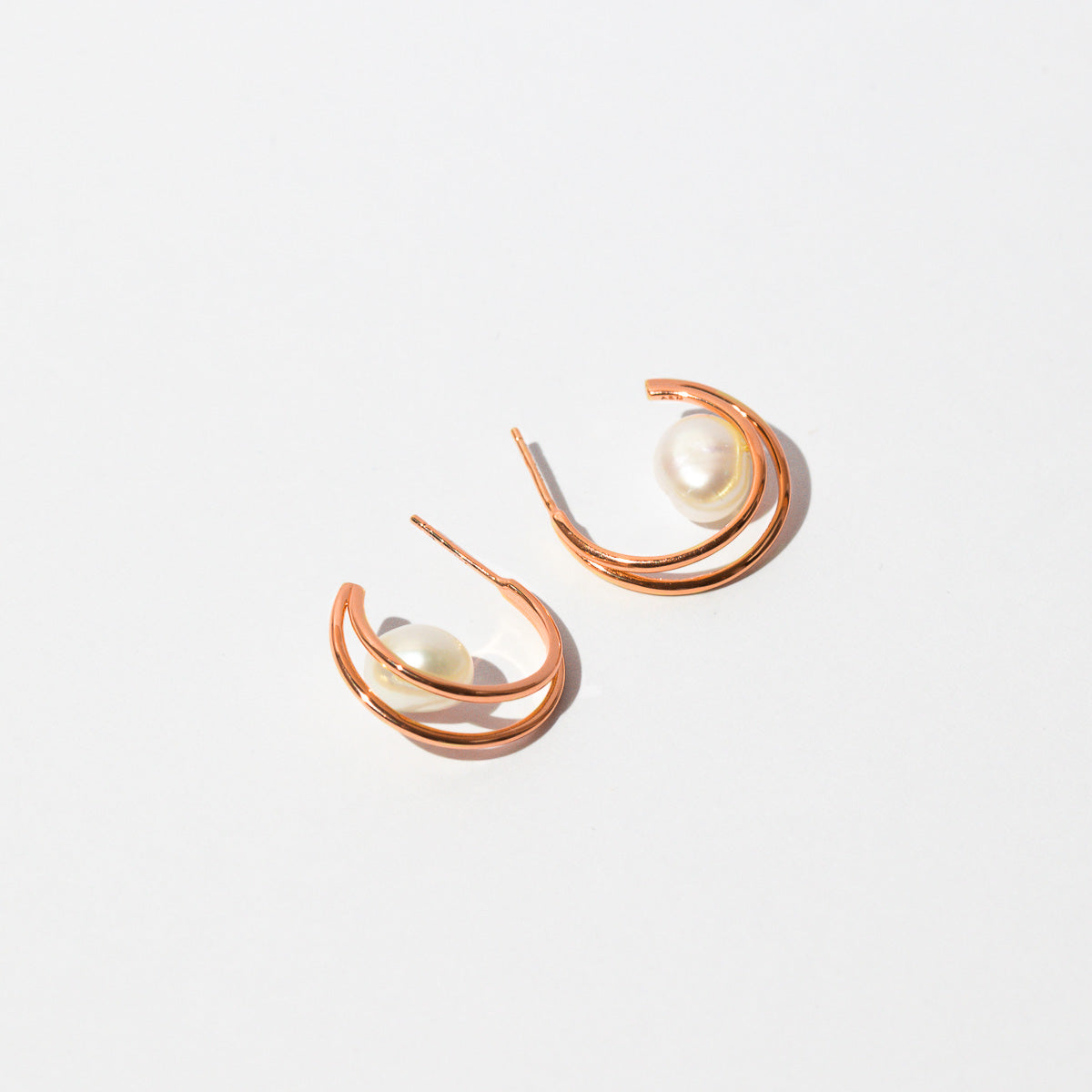 Opulent Pearl Hoops in Rose Gold flat lay