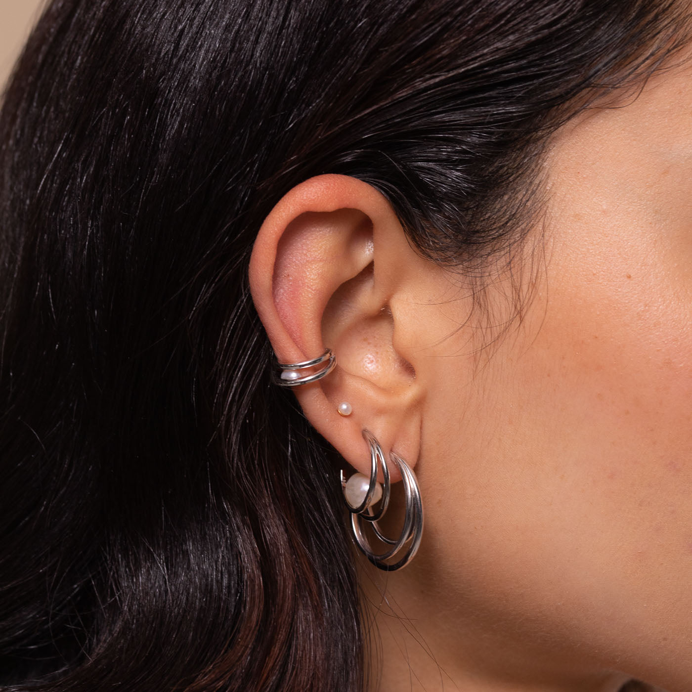 Opulent Pearl Hoops in Silver worn with other earrings