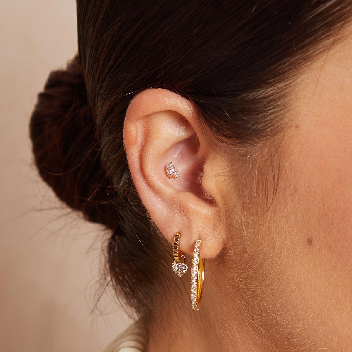 Heart Pave Charm Huggies in Gold worn with other earrings