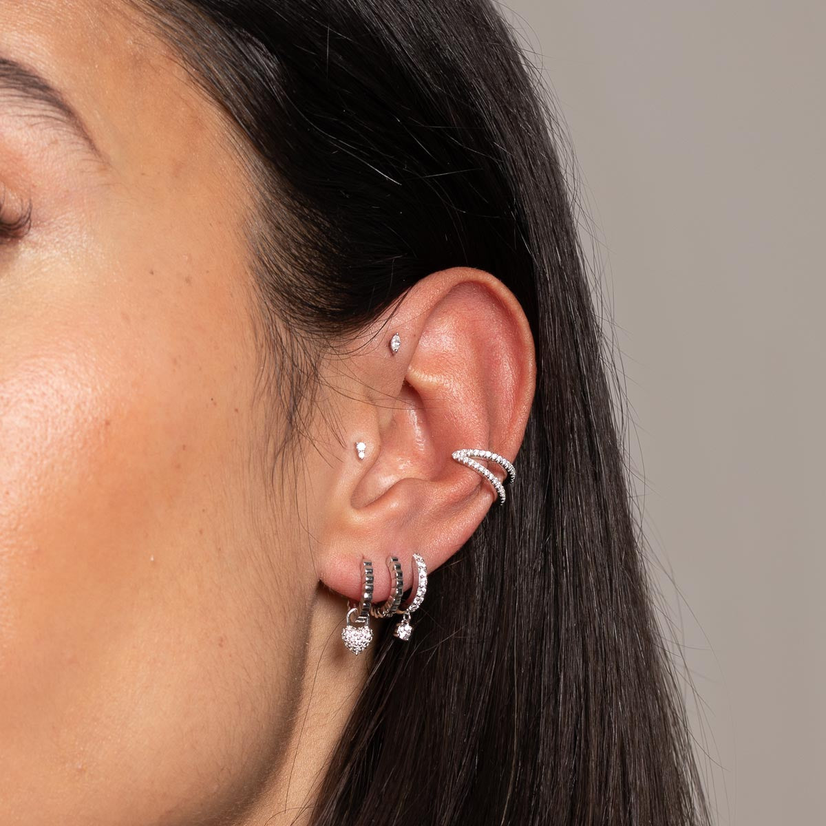 Heart Pave Charm Huggies in Silver worn with other earrings