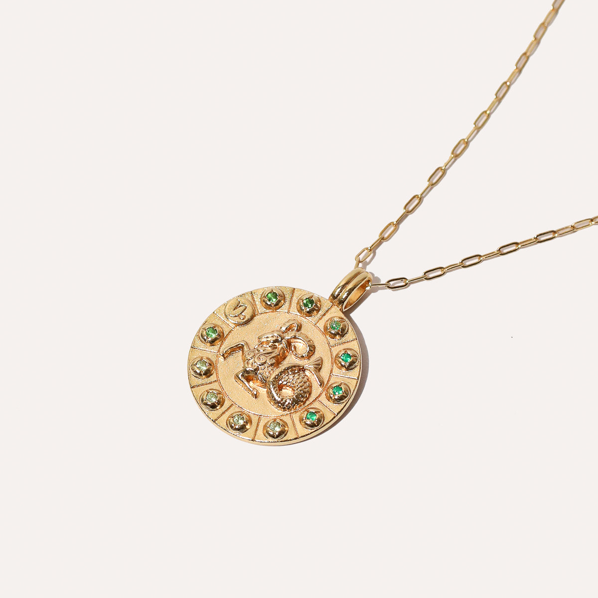 Capricorn Bold Zodiac Pendant Necklace in Gold flat lay