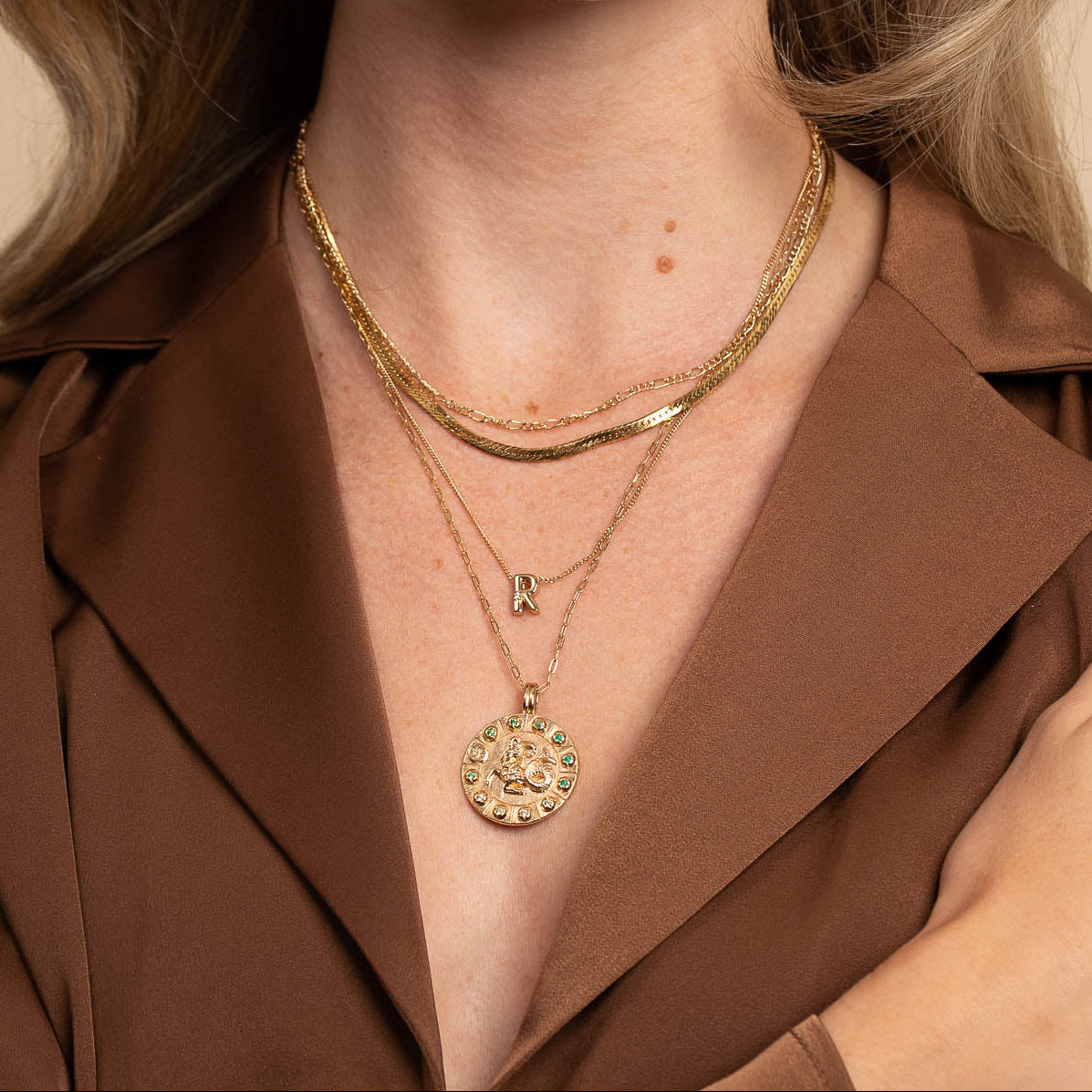 Capricorn Bold Zodiac Pendant Necklace in Gold worn with necklaces