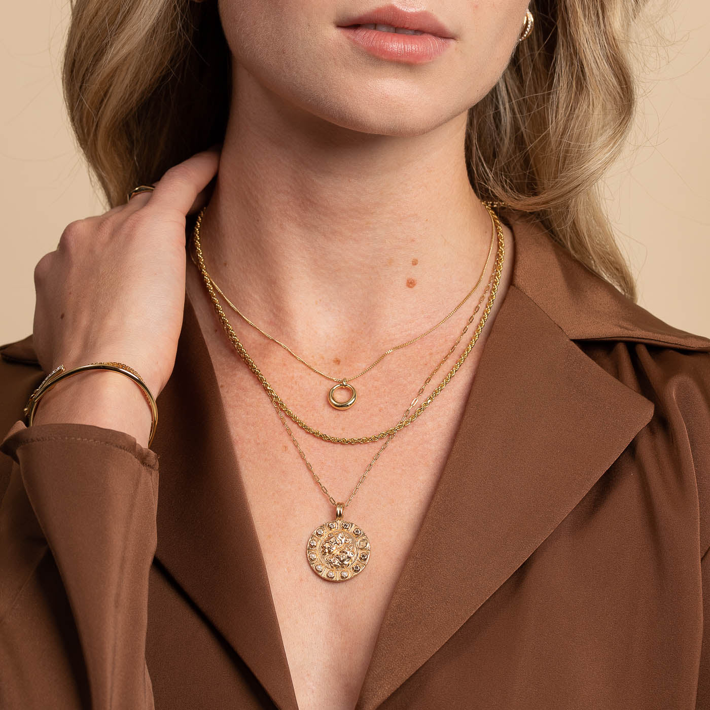 Bold Zodiac Gemini Pendant Necklace in Gold worn layered with halo necklace and rope chain necklace