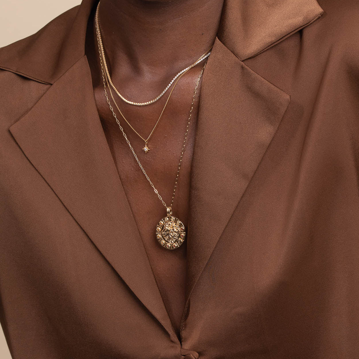 Leo Bold Zodiac Pendant Necklace in Gold worn layered with tennis chain necklace and twilight star pendant necklace