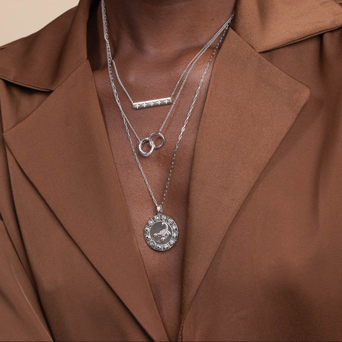Scorpio Bold Zodiac Pendant Necklace in Silver worn layered with necklaces