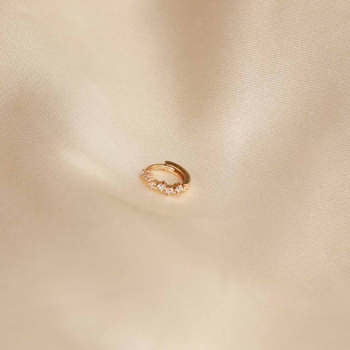 Flat lay image of the Cluster Hoop 6.5mm in Gold