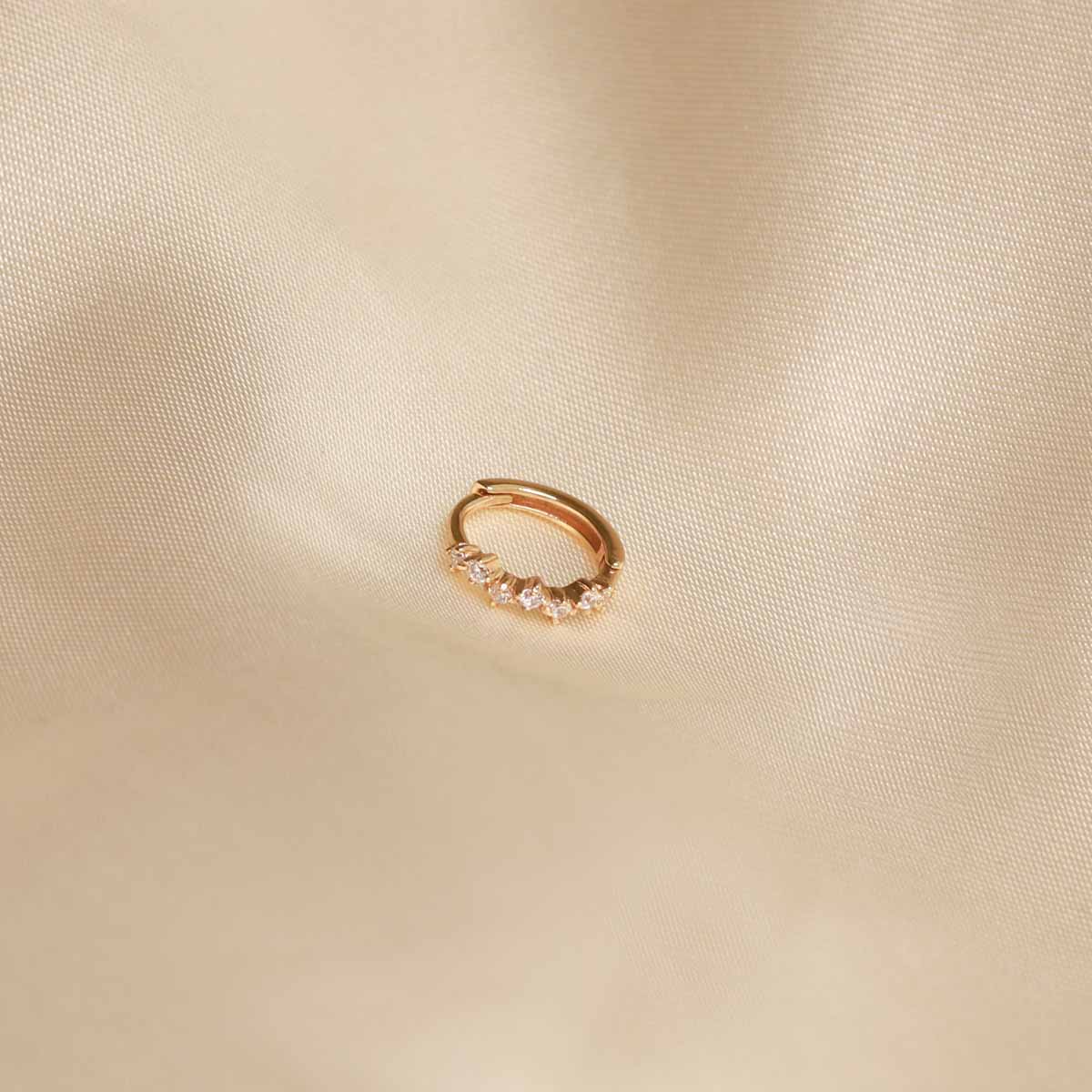 Flat lay image of Worn shot of Cluster Hoop 8mm in Gold