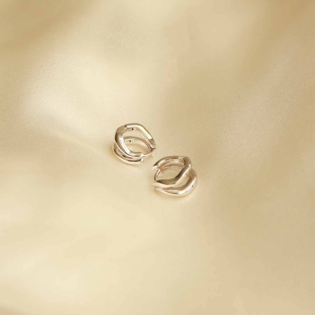 Flat lay shot of Molten Duo Huggies in Silver