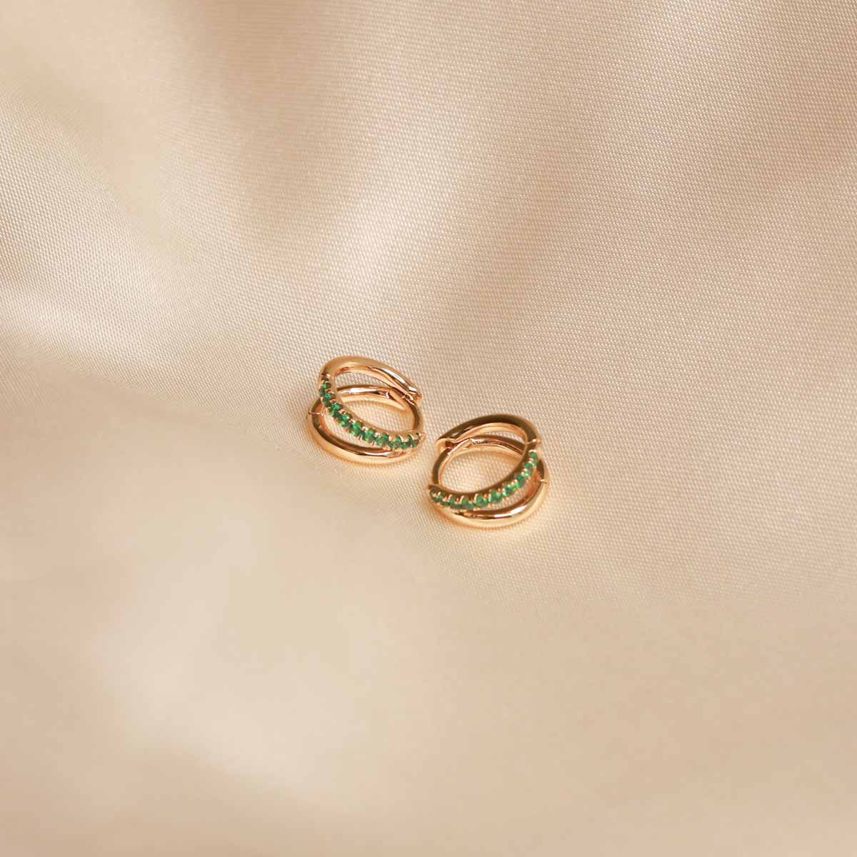 Flat lay shot of Duo Emerald Hoops in Gold