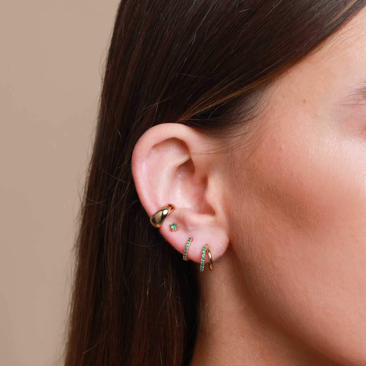 Worn shot of Duo Emerald Hoops in Gold