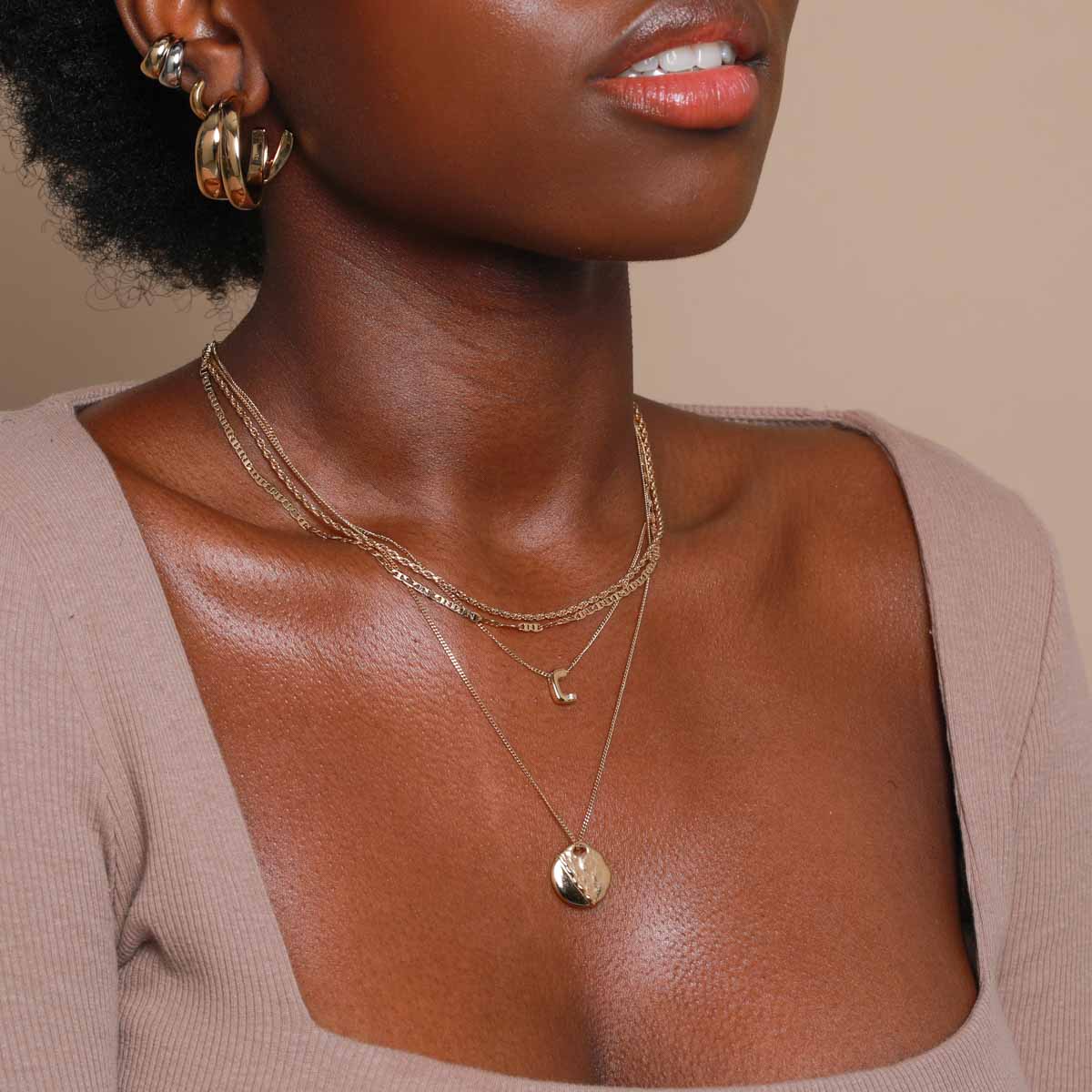 C Initial Pendant Necklace in Gold worn with duo chain necklace and molten coin pendant necklace