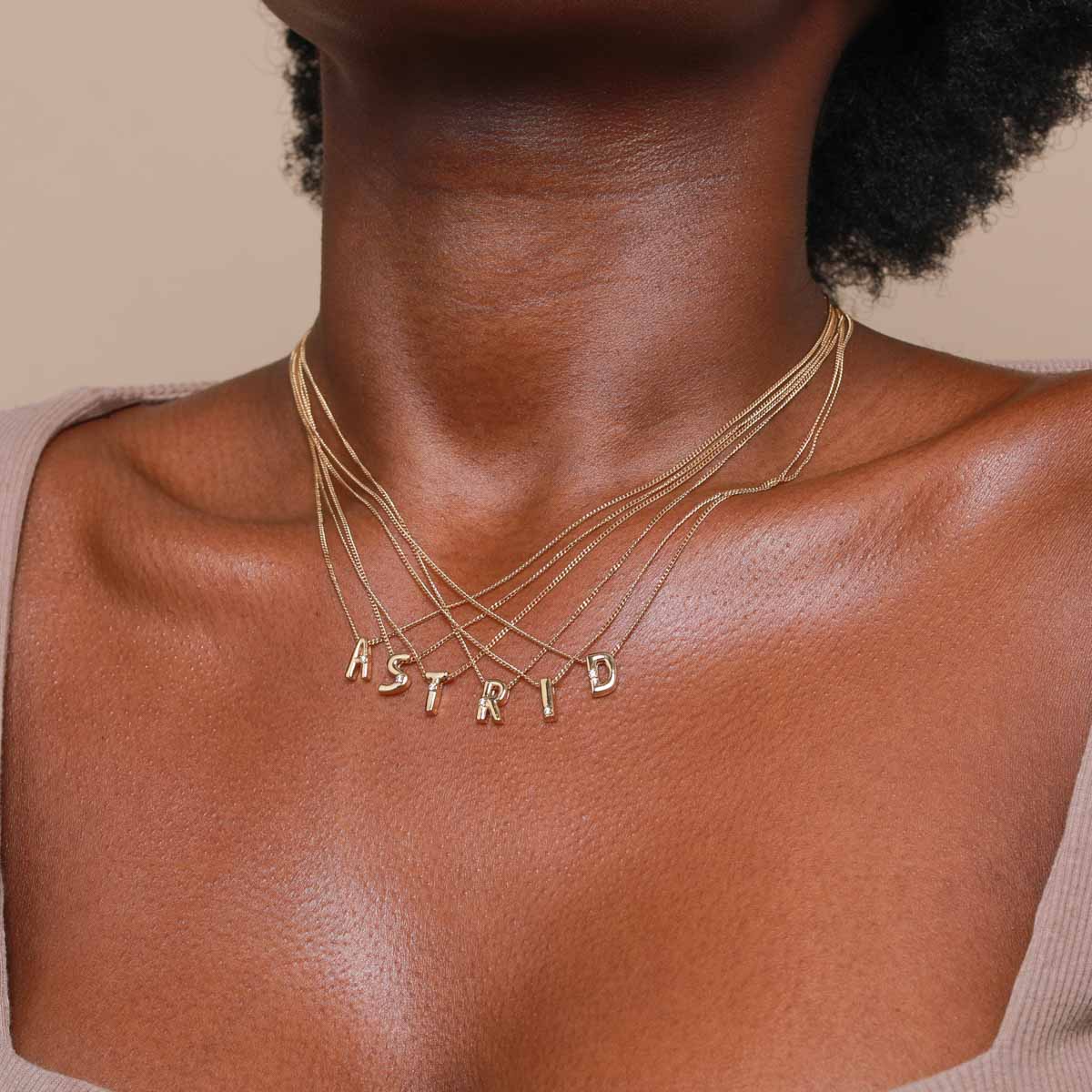 R Initial Pendant Necklace in Gold worn with other letters