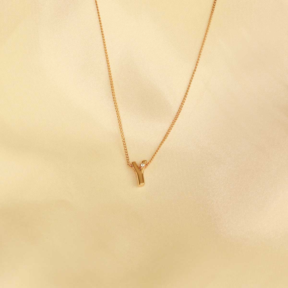 Flat lay shot of Y Initial Pendant Necklace in Gold