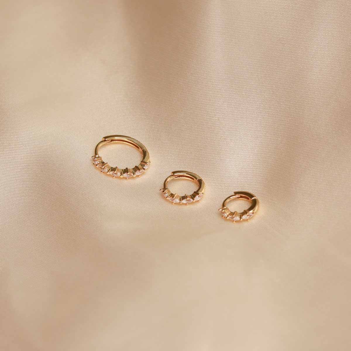 Flat lay shot of Navette Hoop in Gold in all sizes