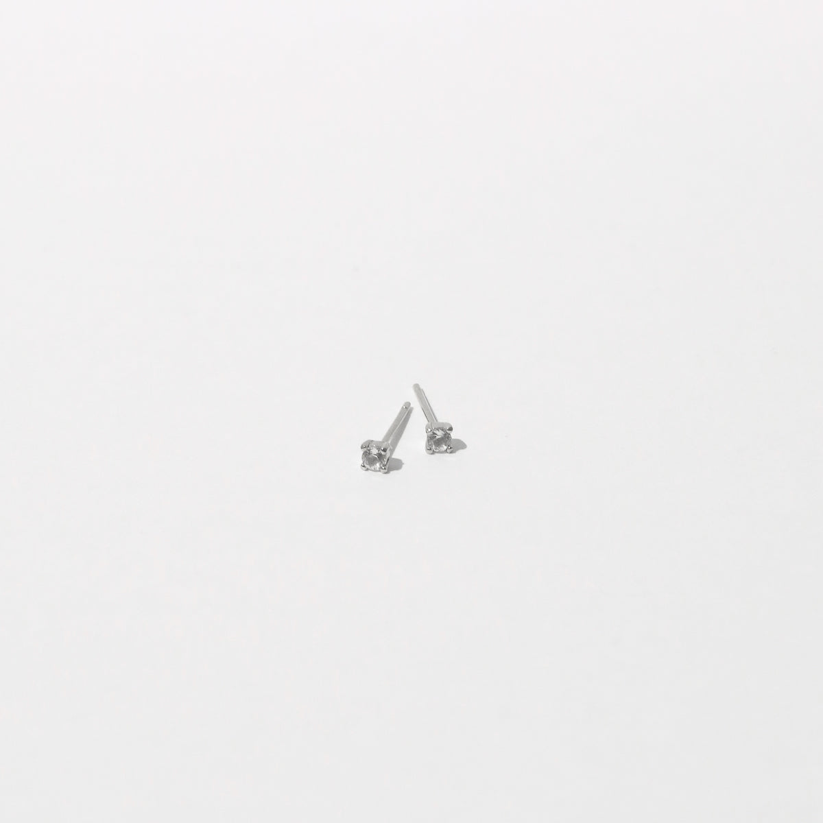 Topaz Stud Earrings in Solid White Gold flat lay