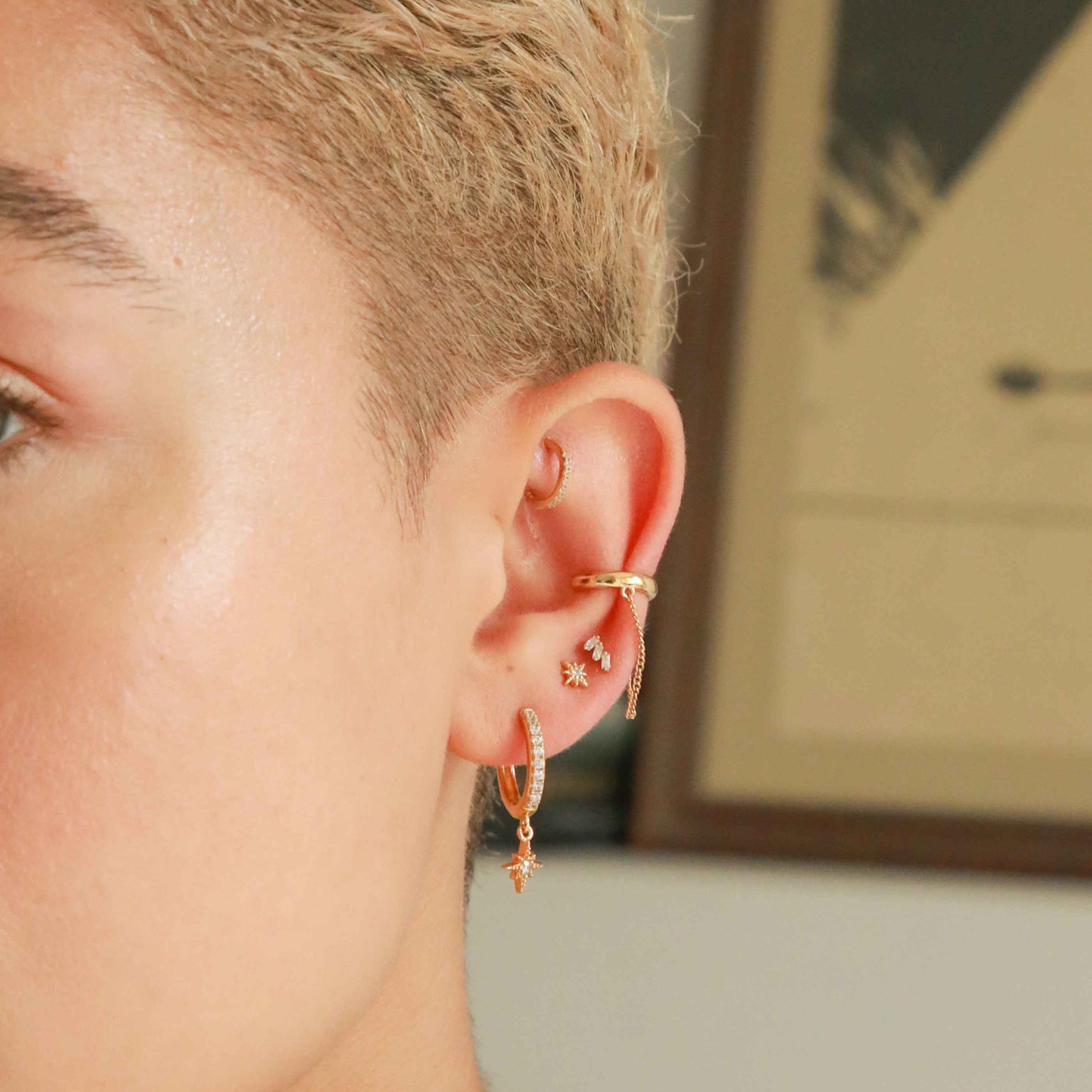 Crystal Star Hoops in Gold worn with other gold earrings