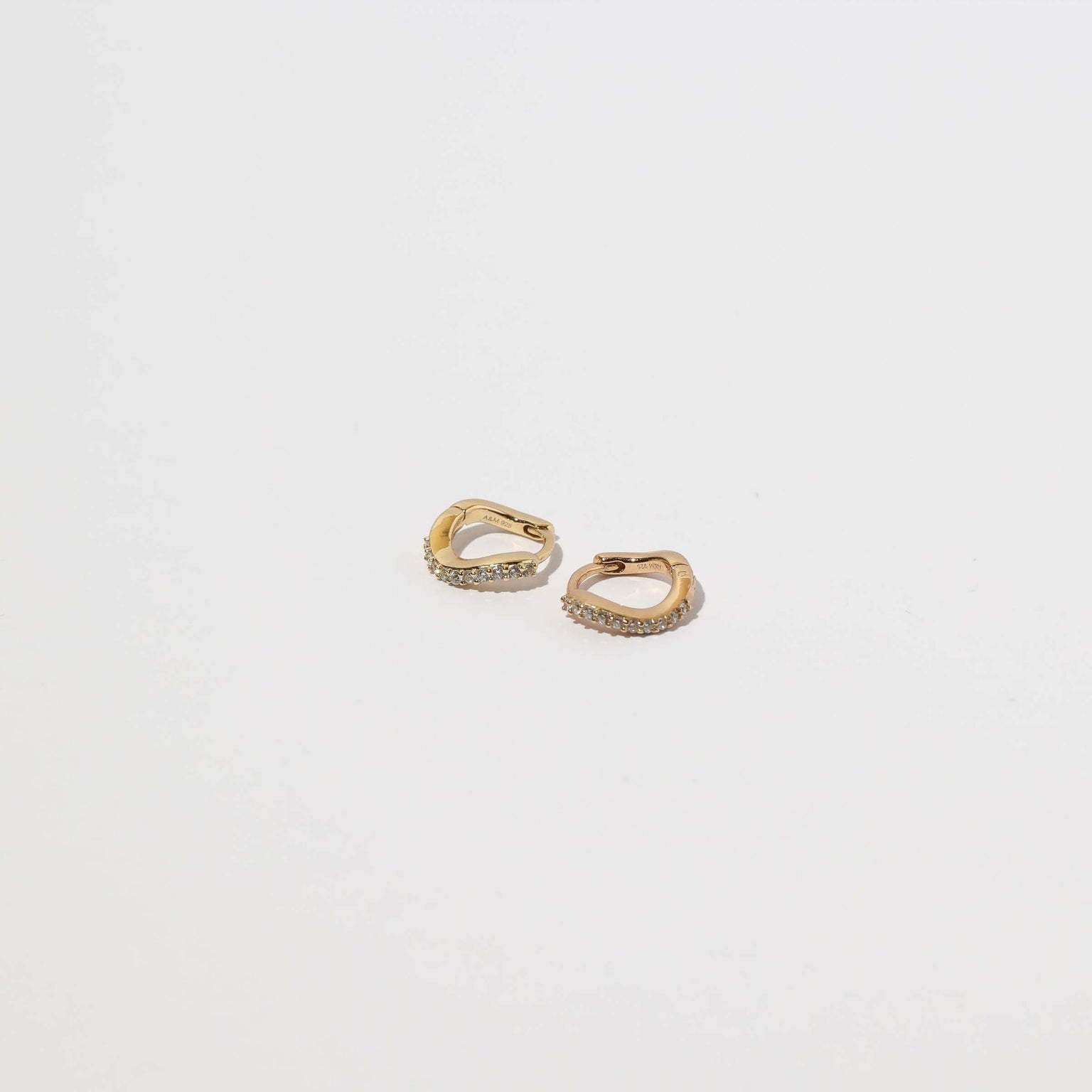 Wave Crystal Huggies in Gold flat lay
