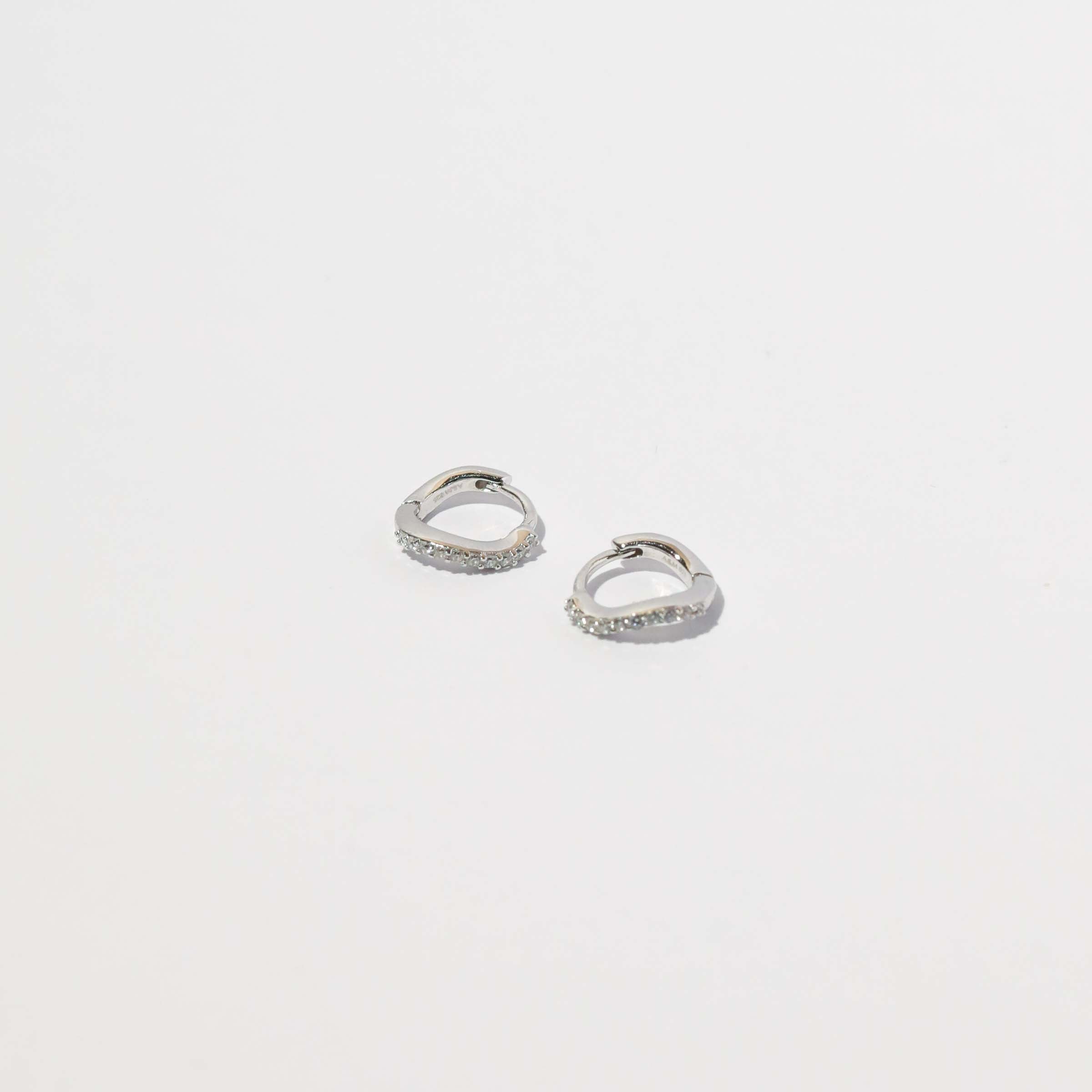Wave Crystal Huggies in Silver flat lay