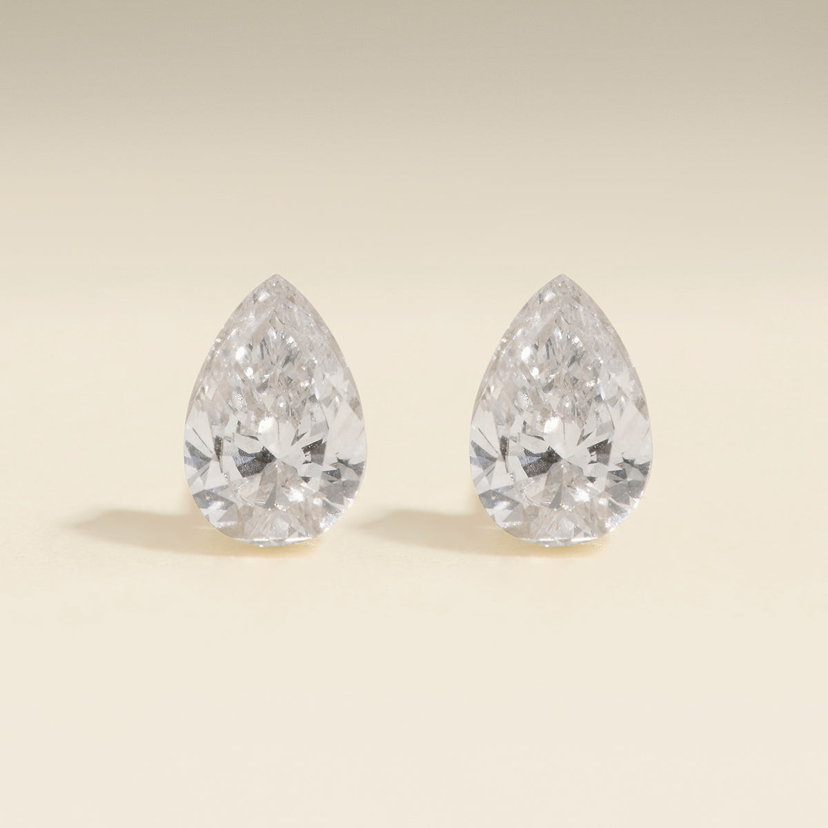Floating Pear Diamond Stud Earrings in Solid Gold