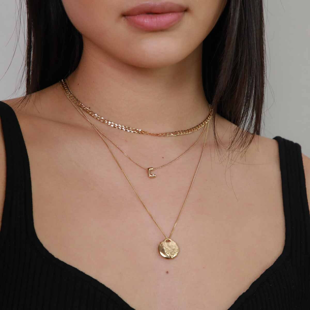 C Initial Pendant Necklace in Gold worn layered with duo chain necklace and molten coin pendant necklace