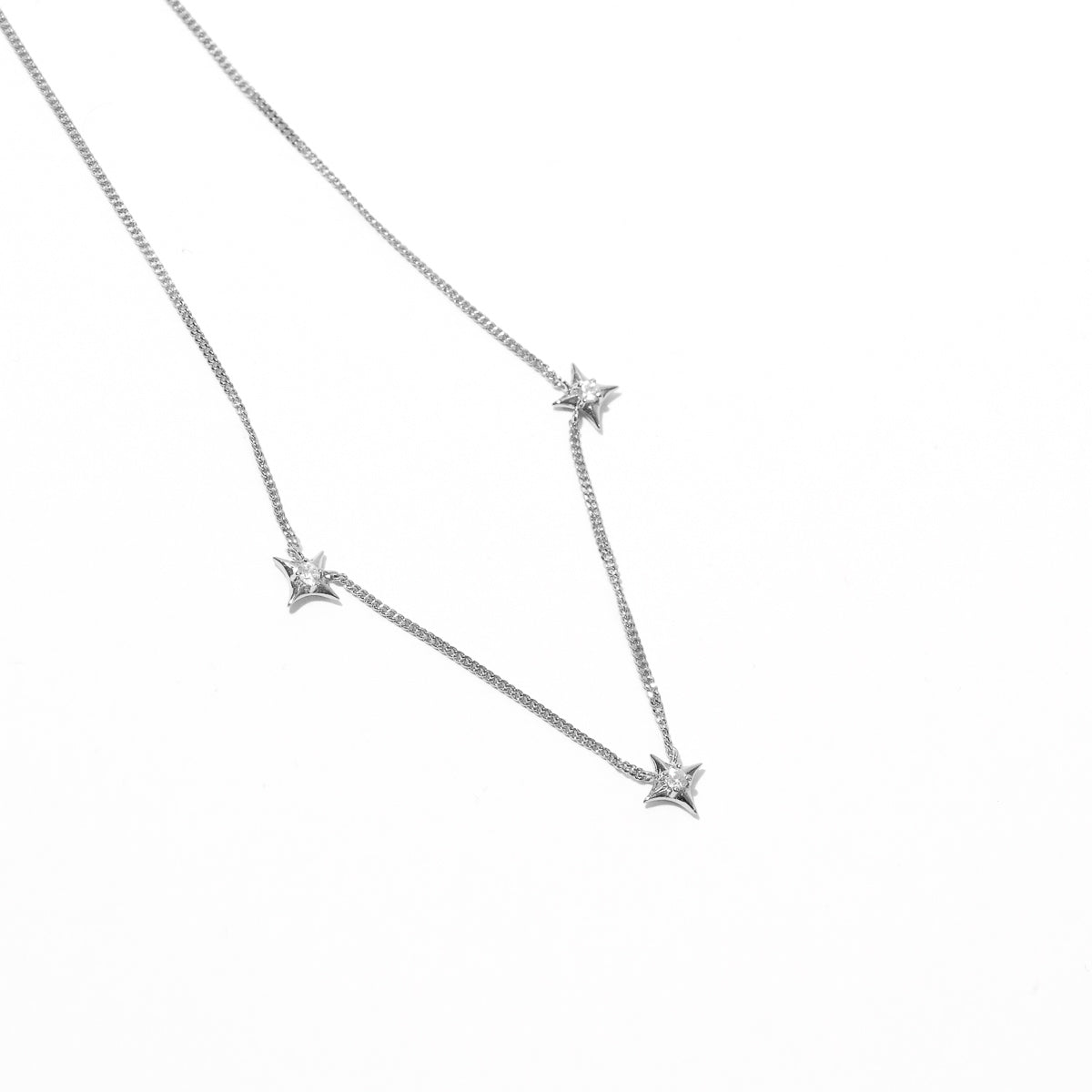 Cosmic Star Charm Necklace in Silver flat lay