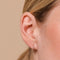 Orbit Crystal Huggies in Rose Gold worn