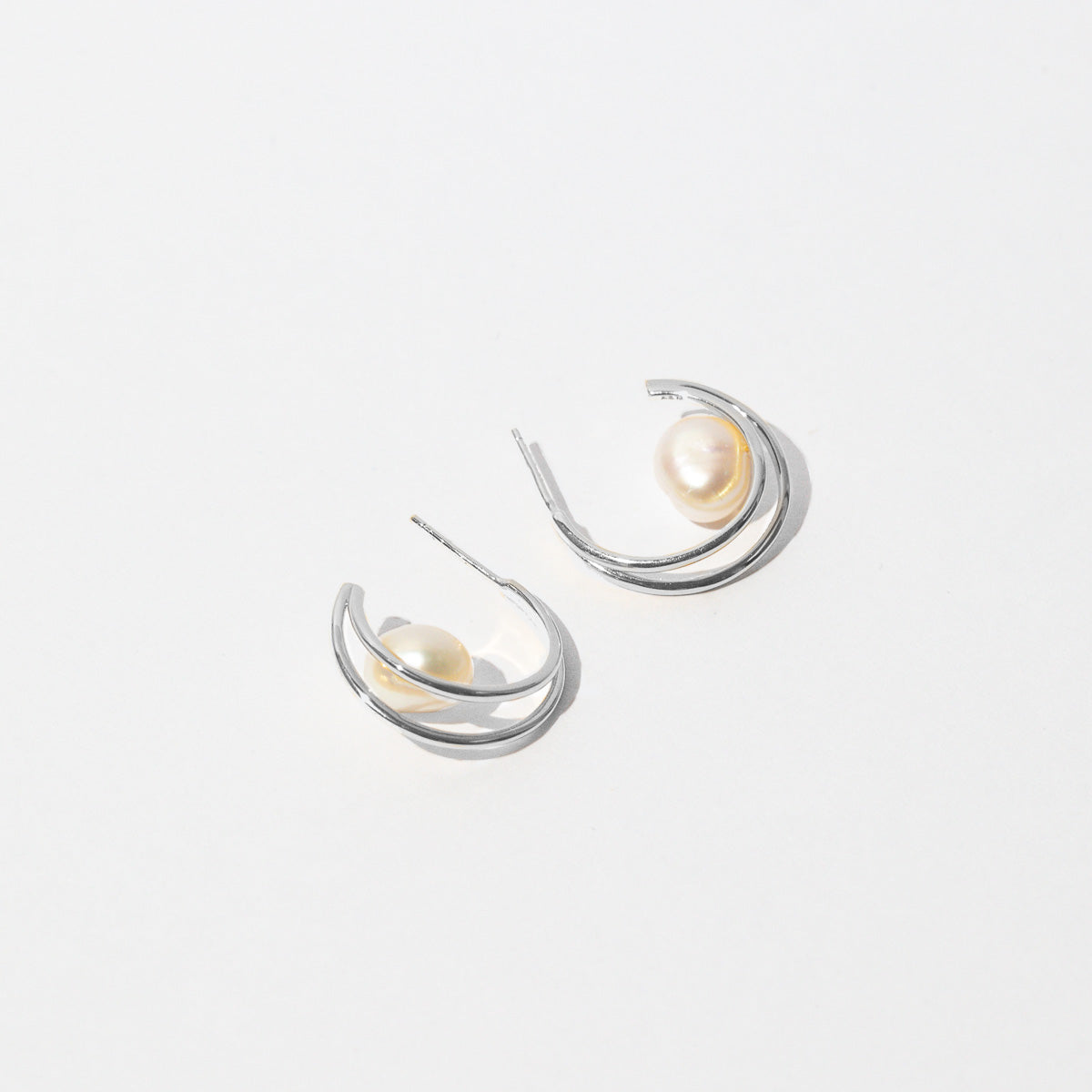 Opulent Pearl Hoops in Silver flat lay