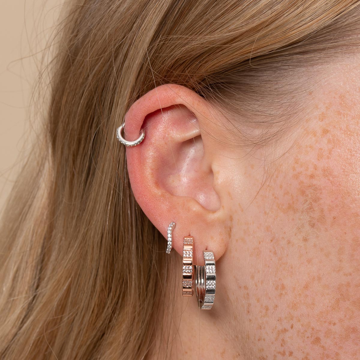 Pleated Crystal Hoops in Rose Gold worn layered with earrings