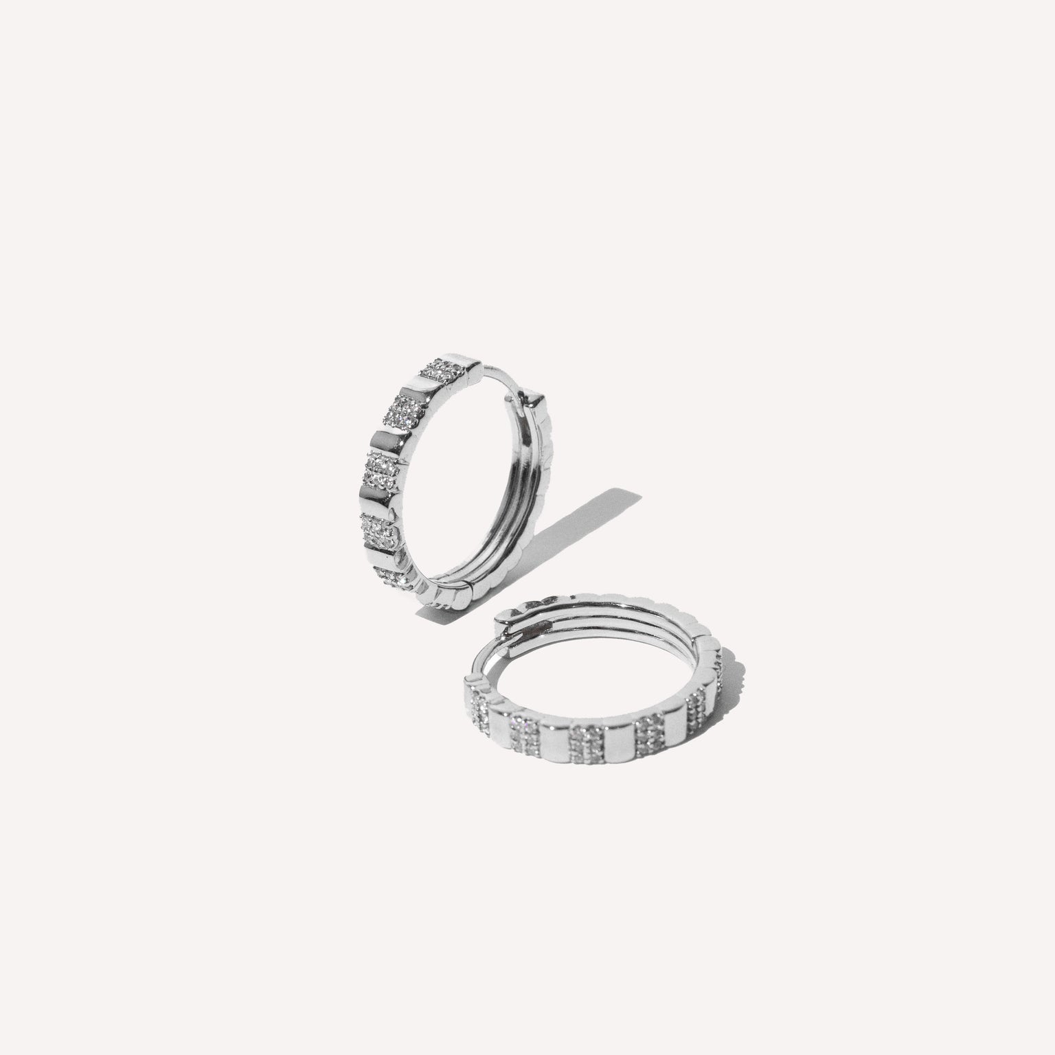 Pleated Crystal Hoops in Silver flat lay