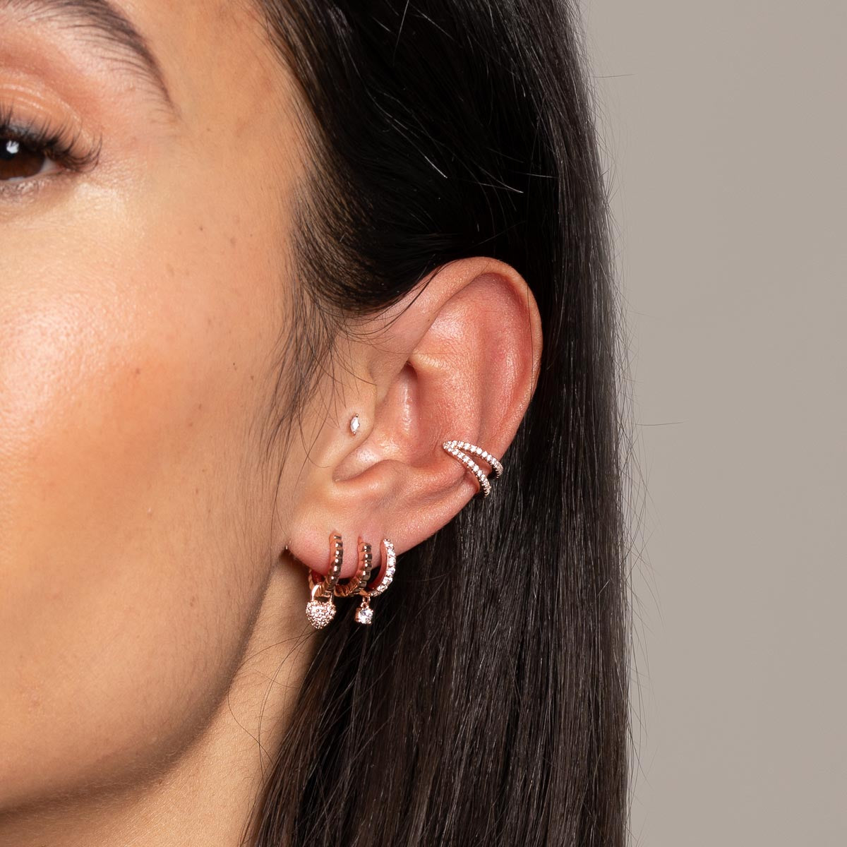 Heart Pave Charm Huggies in Rose Gold worn with other earrings