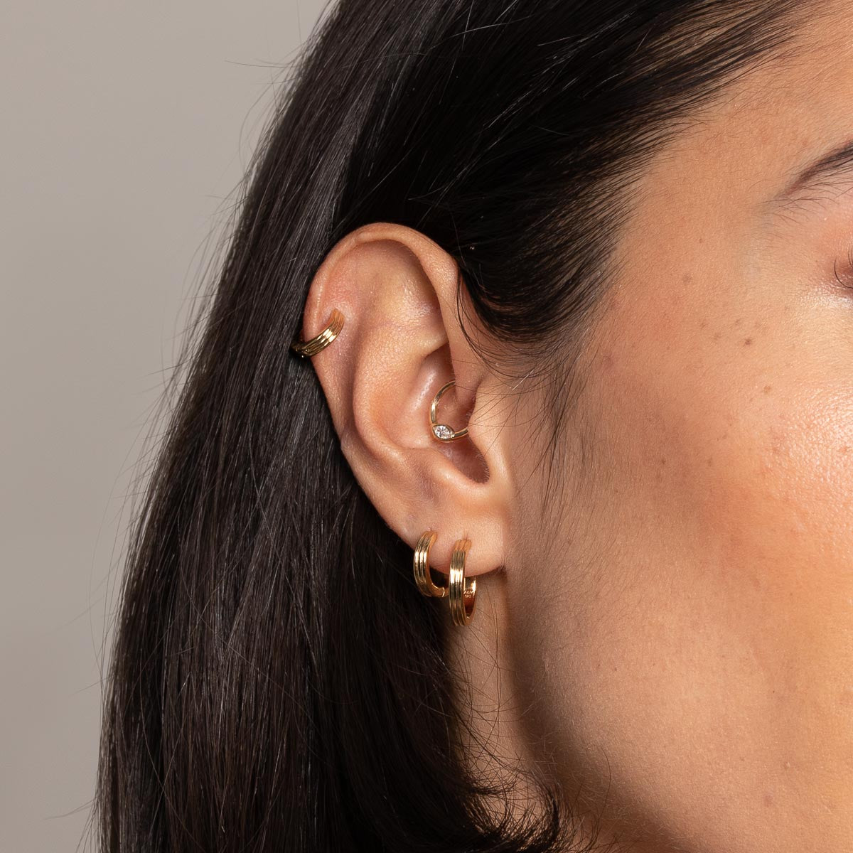Pleated Hoop 6.5mm in Gold worn with other earrings