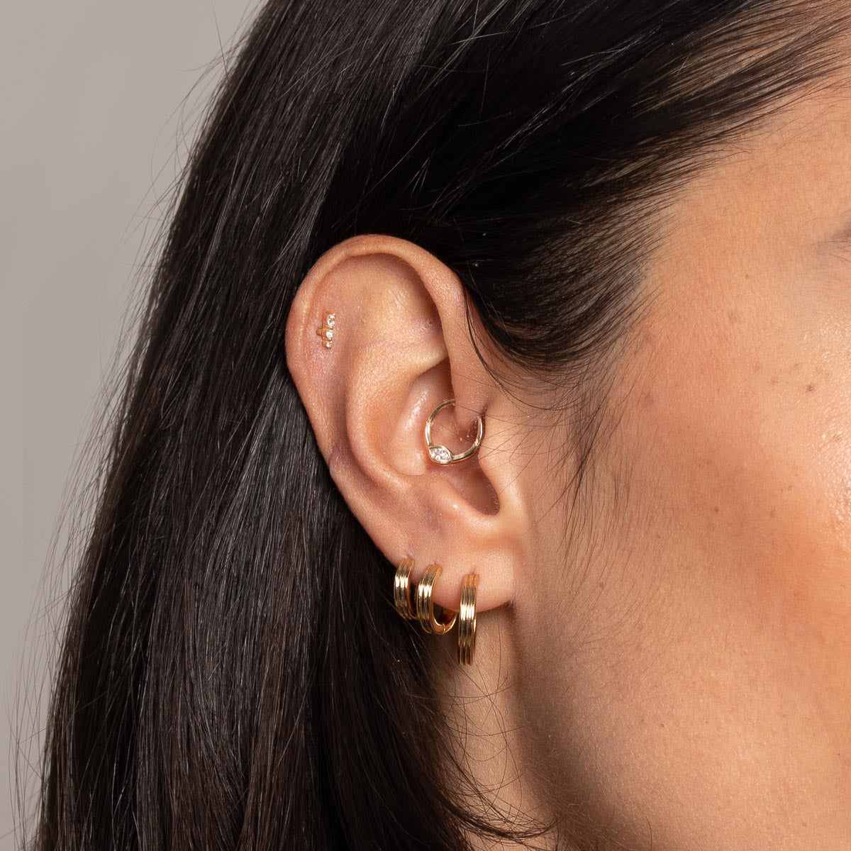 Pleated Hoop 6.5mm in Gold worn with other earrings