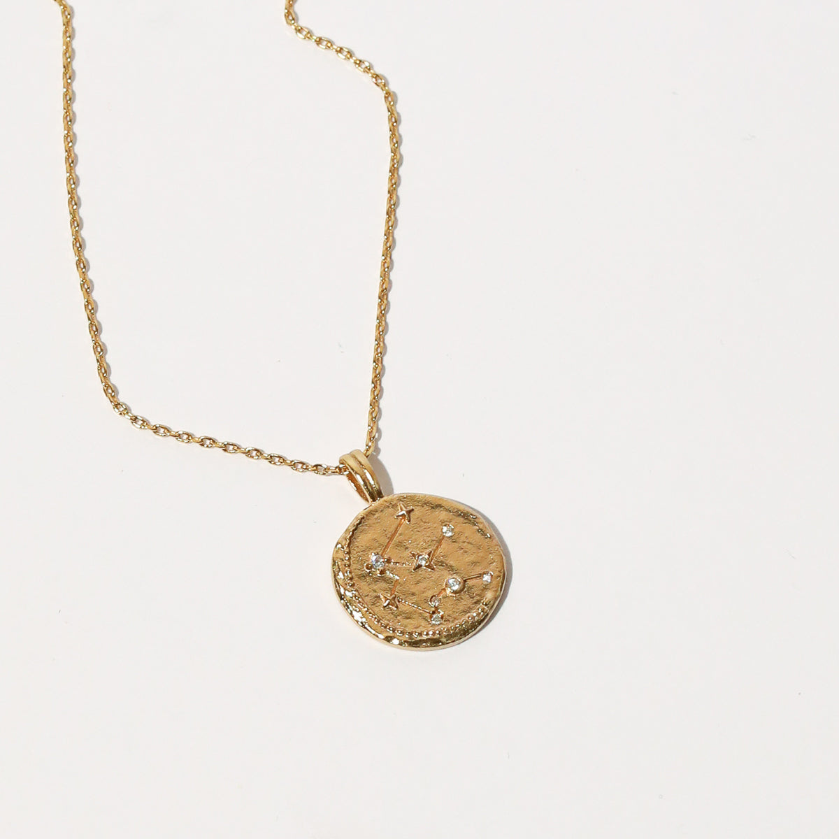 Close up shot of the front of the Aquarius Zodiac Pendant Necklace in Gold