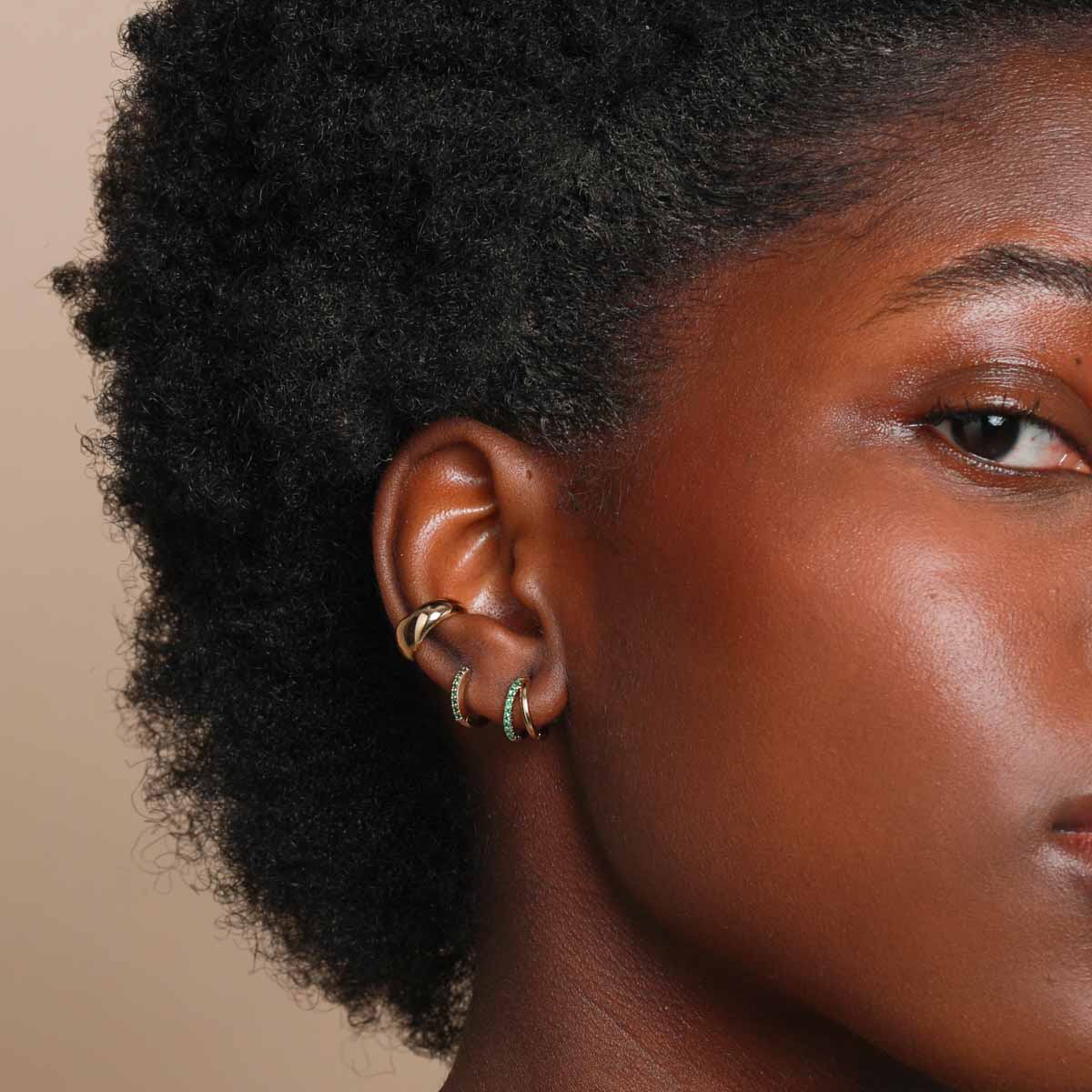 Worn shot of Duo Emerald Hoops in Gold