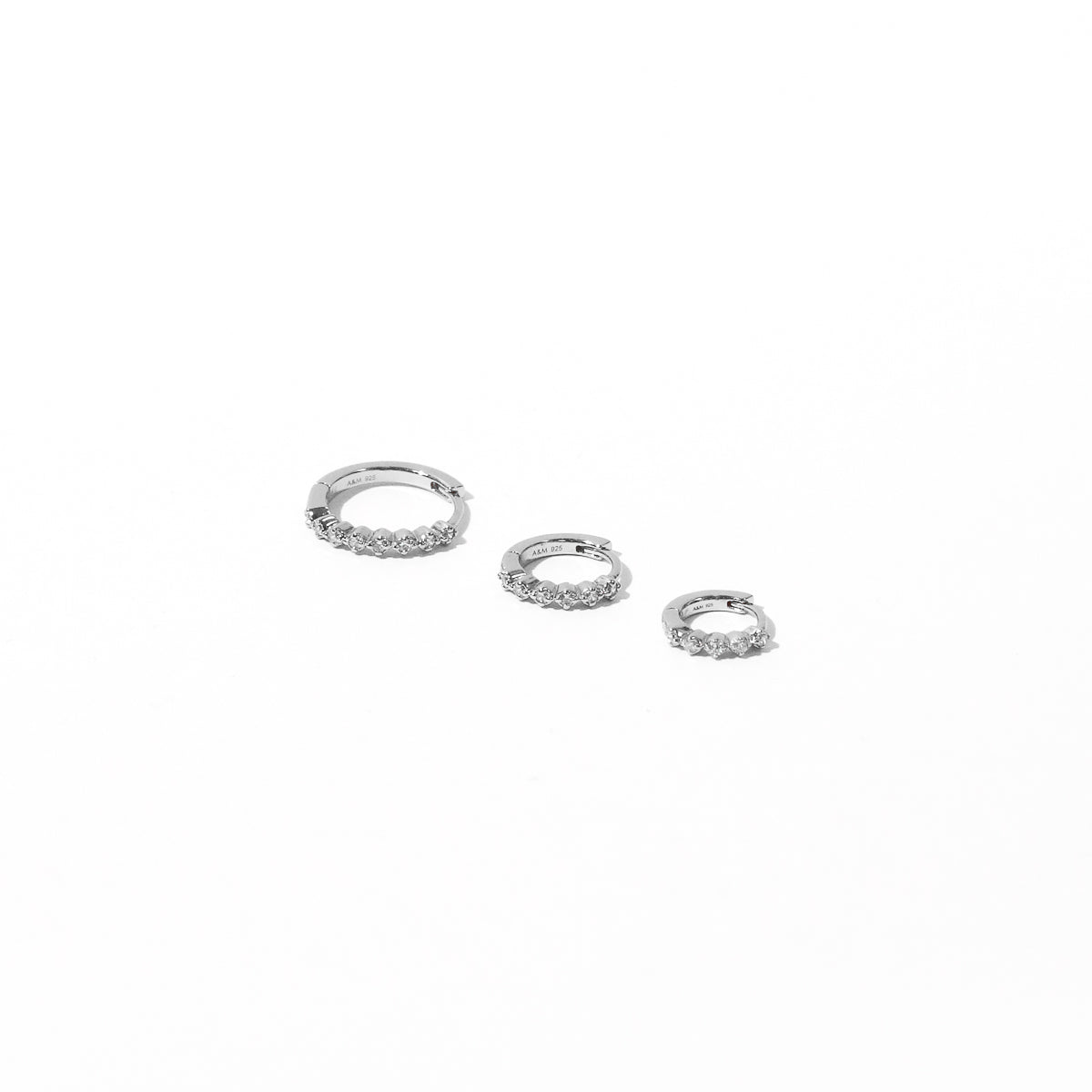 Illume Crystal 6.5mm, 8mm, 11.5mm Hoops in Silver flat lay shot
