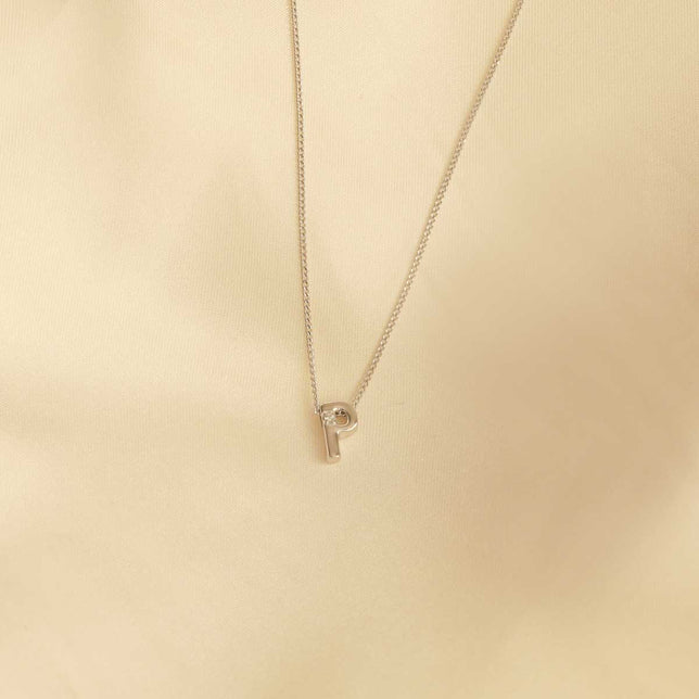 Flat lay shot of P Initial Pendant Necklace in Silver