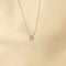 Flat lay shot of U Initial Pendant Necklace in Silver