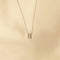 Flat lay shot of W Initial Pendant Necklace in Silver