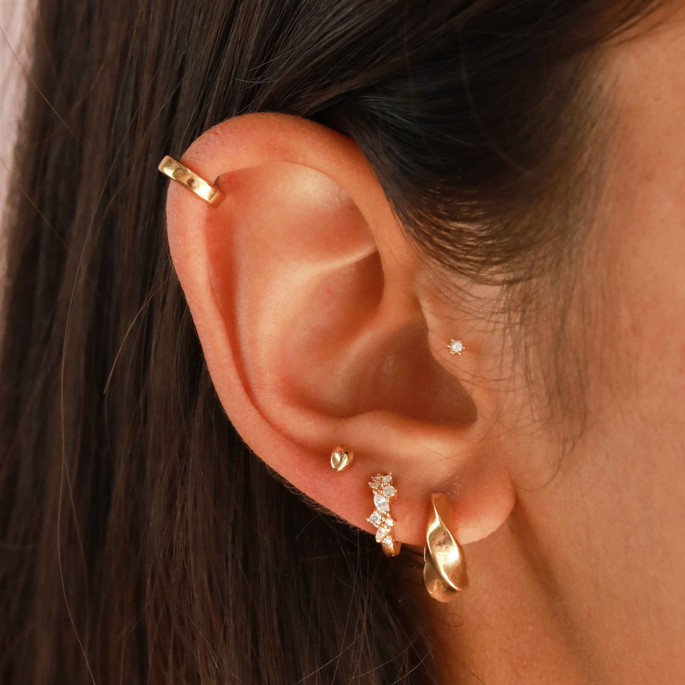 Crystal Cluster Huggies in Gold worn with Elemental Hoops, Molten Studs, Flora Tiny Barbell and an ear cuff