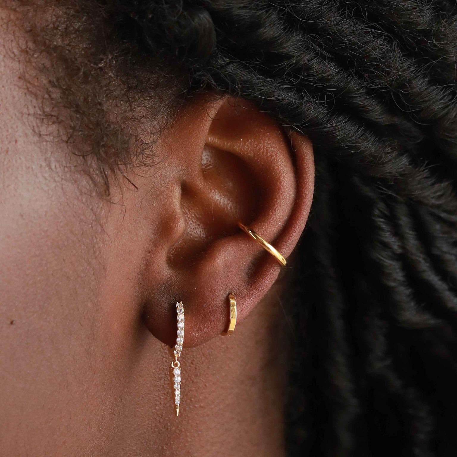 Crystal Spike Huggies in Gold worn with mystic simple huggie in gold and basic ear cuff