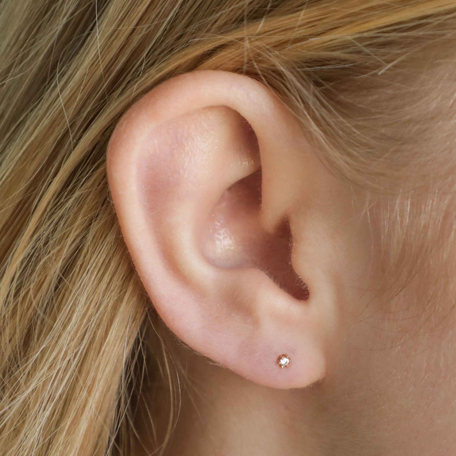 Flora Tiny Barbell in Gold worn in lobe
